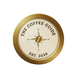 The Coffee Guide Seal of Quality and Approval. A gold circle with the coffe guide est 2066 and a NSEW compass in the center