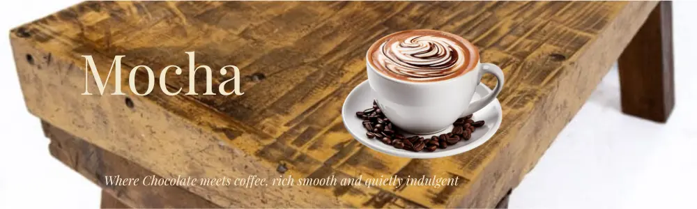 White ceramic cup of mocha with swirls of choclate on a n old wooden table.