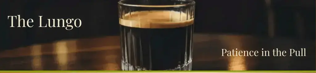 the Lungo Coffee in a glass tumblar sitting on a old wooden table in an Italian styled coffee shop