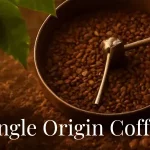 single origin coffee red coffee cherries with a roasting tray and a cup of single origing coffee